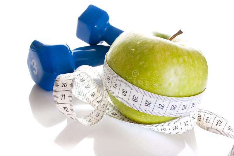 Dumbbells, fresh green apple and measure tape isolated on white background. Dumbbells, fresh green apple and measure tape isolated on white background