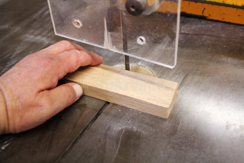 Band saw and hand stock photo