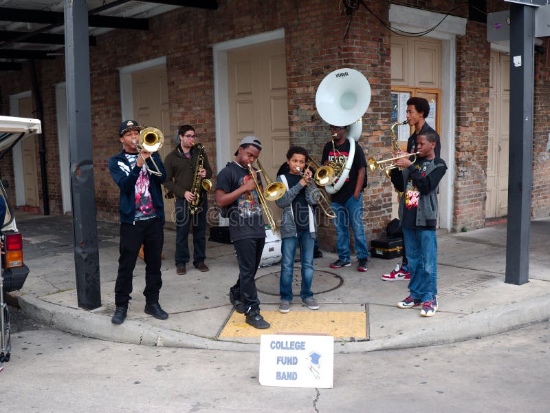 New Orleans, Louisiana, USA - 2019: A jazz band conformed of young men performs at a street corner in the French Quarter to collect money for College. New Orleans, Louisiana, USA - 2019: A jazz band conformed of young men performs at a street corner in the French Quarter to collect money for College.