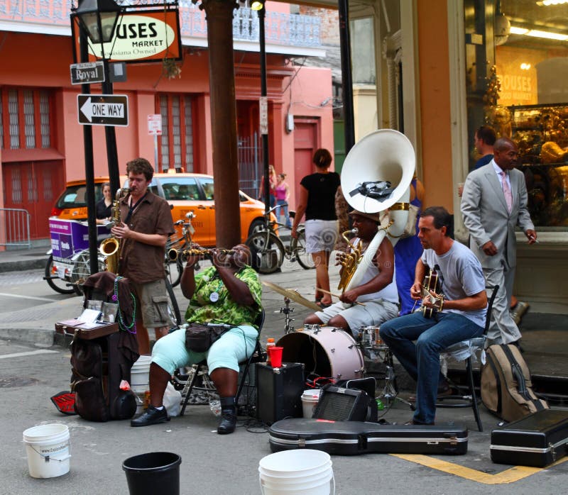 NEW ORLEANS - SEP 07 : A street jazz band plays on Royal Street in the French Quarter of New Orleans. Taken September 07, 2013 in New Orleans, LA. NEW ORLEANS - SEP 07 : A street jazz band plays on Royal Street in the French Quarter of New Orleans. Taken September 07, 2013 in New Orleans, LA.