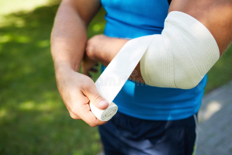 Bandaging arm royalty free stock photography