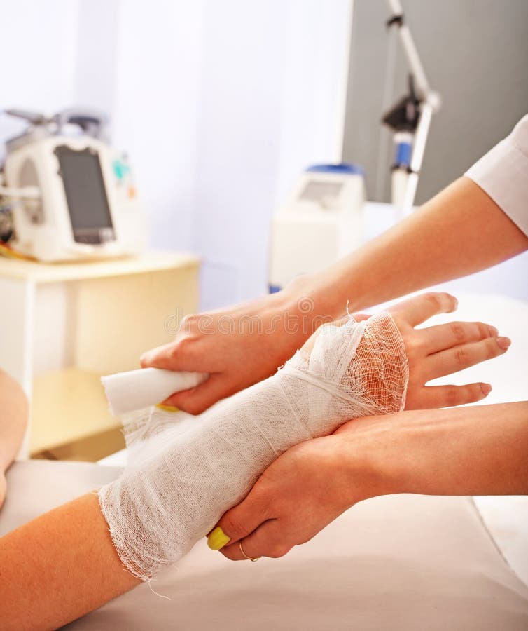 Bandaging patient in hospital. stock photos