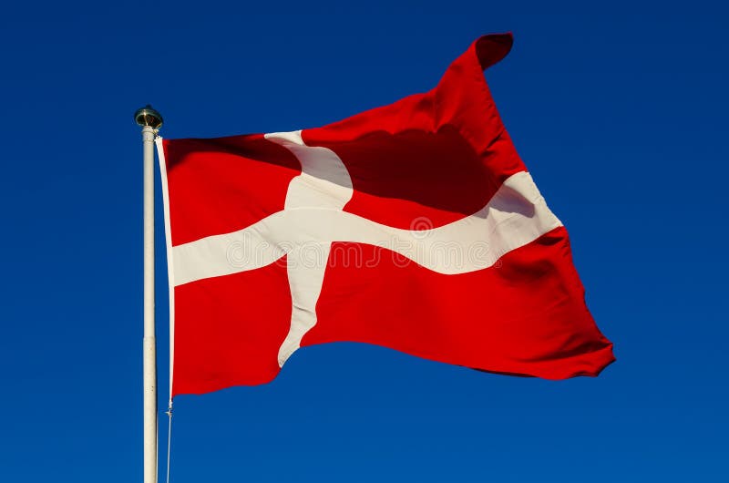 Flag of Denmark against the blue sky, national patriotic background. Flag of Denmark against the blue sky, national patriotic background