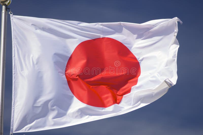 Closeup of a Japanese flag with blue sky. Closeup of a Japanese flag with blue sky