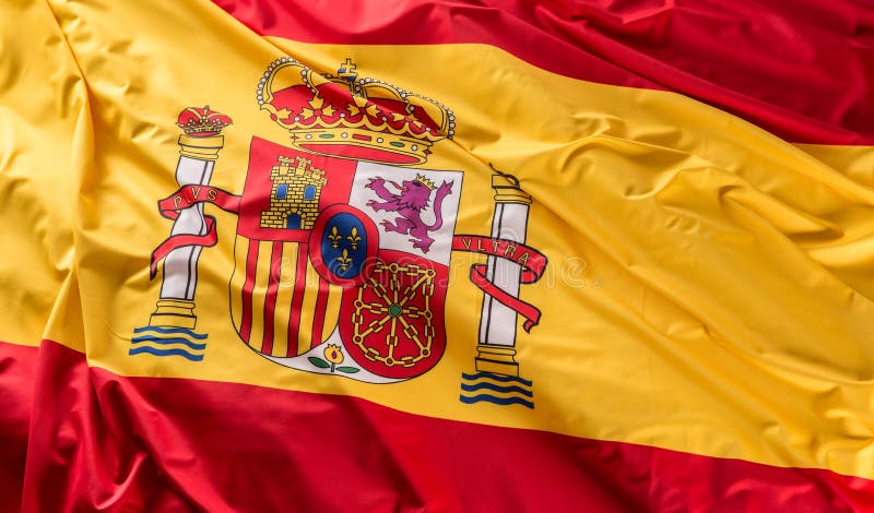Bandera de España de la seda Colores nacionales españoles con el emblema imagenes de archivo Bandera de España de la seda Colores nacionales españoles con el emblema imagenes de archivo