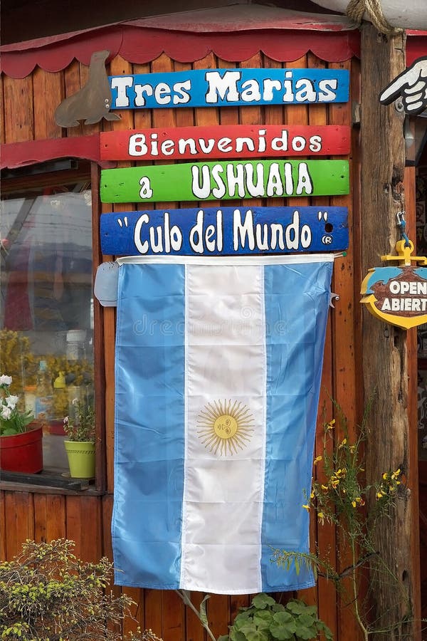 Bandera de la Argentina en la entrada de una agencia turística en Ushuaia, la Argentina fotografía de archivo libre de regalías Bandera de la Argentina en la entrada de una agencia turística en Ushuaia, la Argentina fotografía de archivo libre de regalías