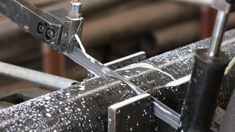 Bandsaw cutting a steel pipe stock photo Bandsaw cutting a steel pipe stock photo