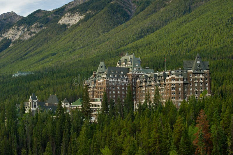 Luxurious Banff Springs Hotel in the Canadian Rockies, Alberta. It looks like a castle among the green trees. Like rocky terrain stock images, royalty-free photos and pictures