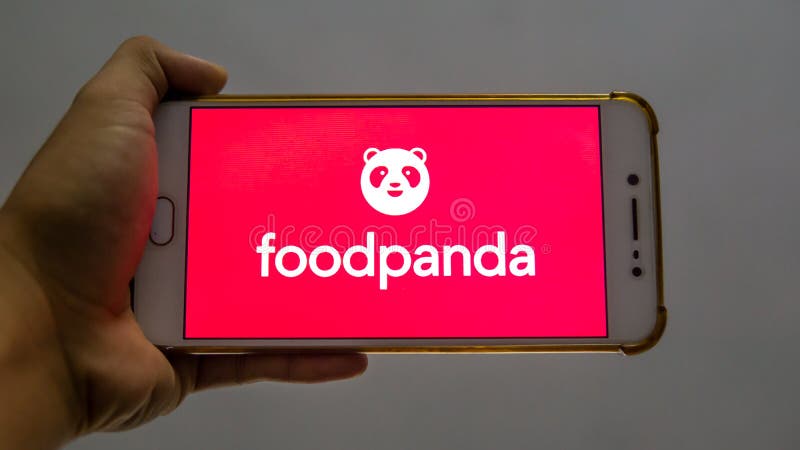 Bangi, Malaysia - October 10, 2019: Hand holding a smartphone with the FoodPanda application logo on the screen. FoodPanda is a very famous online food delivery brand