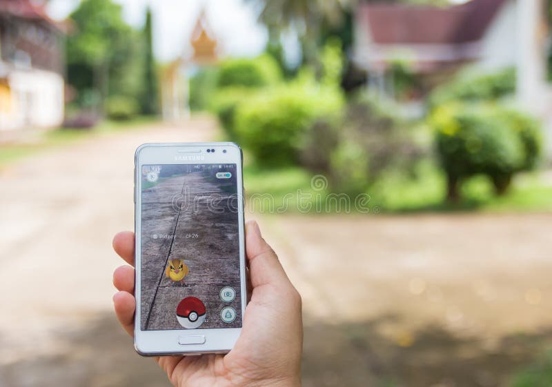 Royalty-Free photo: Person holds smartphone with Pokemon Go application  running