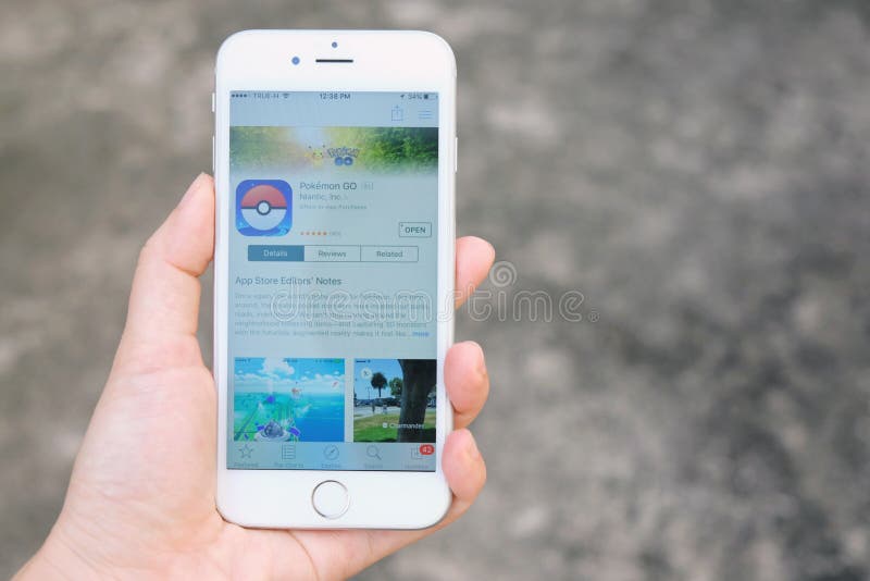 Bangkok, Thailand - August 6, 2016 : Hand holding Apple iPhone6s Showing Pokemon Go game download from app store, Pokemon Go is a location-based augmented reality mobile game. Bangkok, Thailand - August 6, 2016 : Hand holding Apple iPhone6s Showing Pokemon Go game download from app store, Pokemon Go is a location-based augmented reality mobile game.
