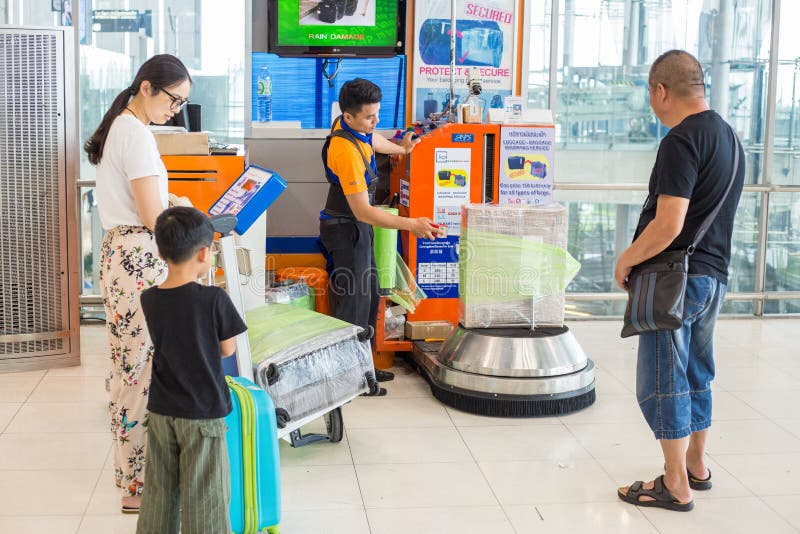 Men at Airport Luggage Wrapping Station Wrap Customers` Box Whil Editorial  Stock Image - Image of safety, wrap: 121845874