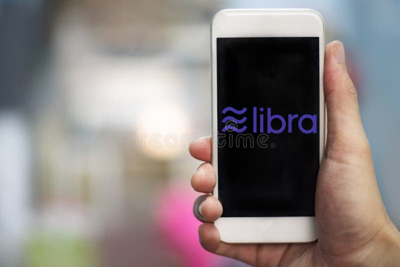 Libra coin logo on smartphone / New project libra a cryptocurrency launched by Facebook looks to mainstream digital currency stock photography Libra coin logo on smartphone / New project libra a cryptocurrency launched by Facebook looks to mainstream digital currency stock photography