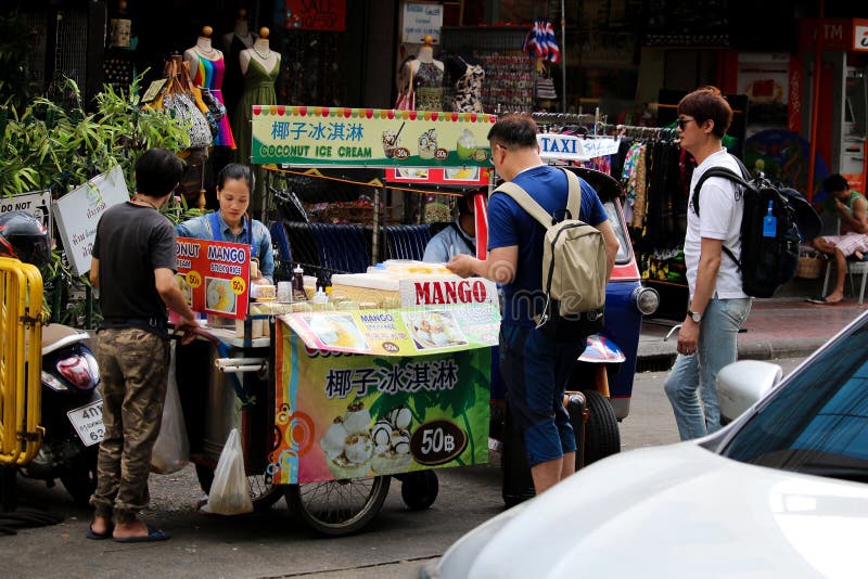 Young women and husband sell  Coconut Ice  Cream and mango sticky rice near Khao San Road