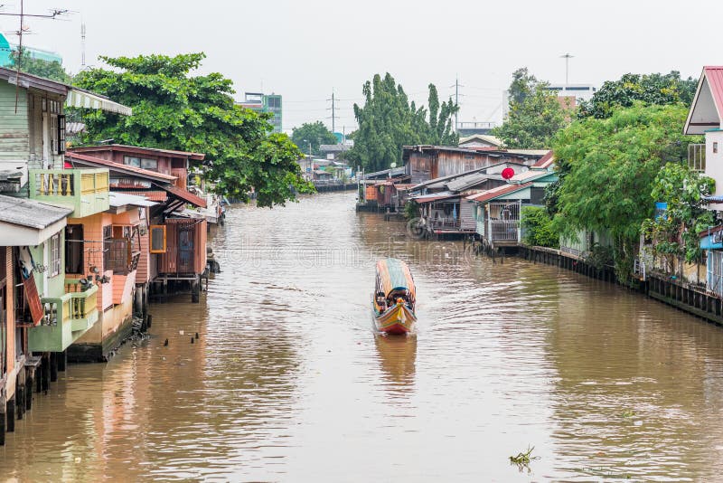 Bangkok, Thailand: Khlong Mon, one of the canals of Thonburi, with houses along it and a tourist boat