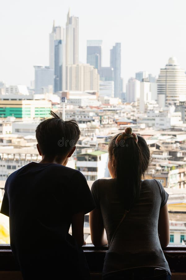 Bangkok, Thailand - March 2019: Asian couple looking out of Golden Mount Wat Saket temple window over royalty free stock photo Bangkok, Thailand - March 2019: Asian couple looking out of Golden Mount Wat Saket temple window over royalty free stock photo