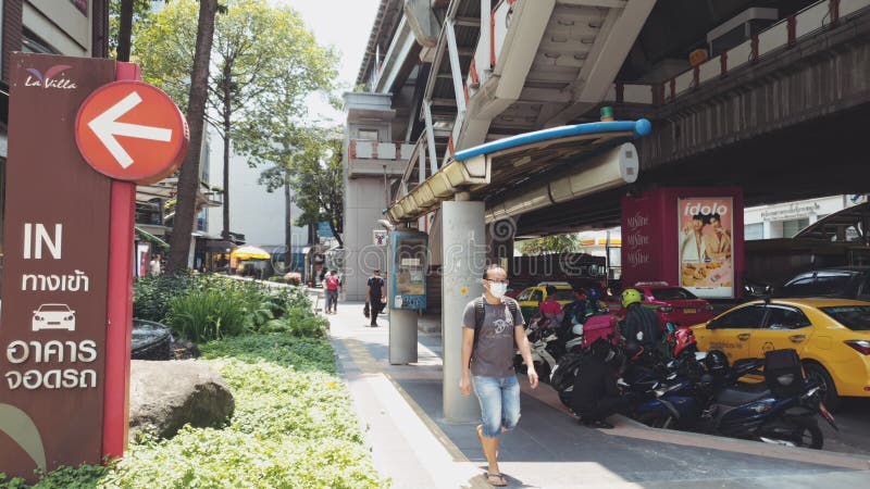 BANGKOK, THAILAND - MARCH 23, 2020: Walking through the empty streets of Bangkok during a pandemic Coronavirus covid-19. People walk in mask. Concept virus stock photography BANGKOK, THAILAND - MARCH 23, 2020: Walking through the empty streets of Bangkok during a pandemic Coronavirus covid-19. People walk in mask. Concept virus stock photography