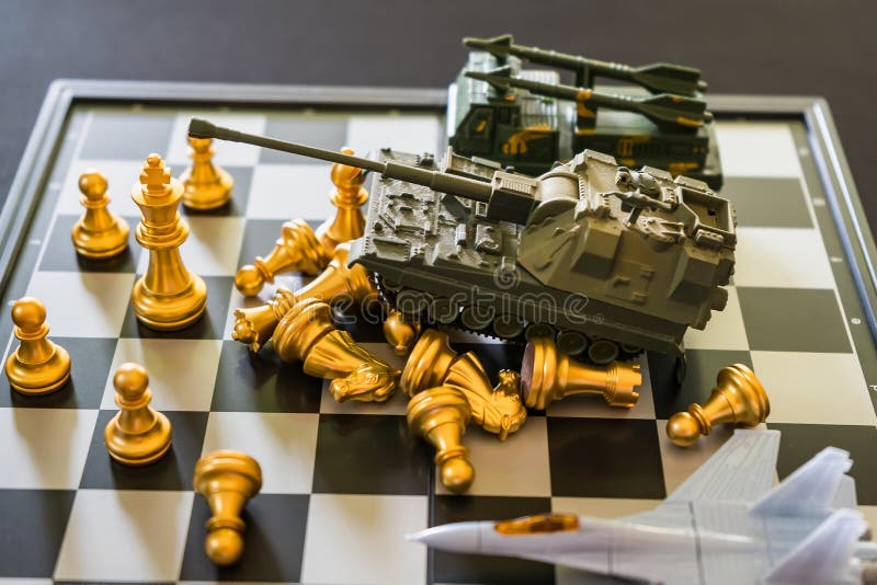 Toy tanks with chess on chessboard. Concept of military strategy., Stock  image