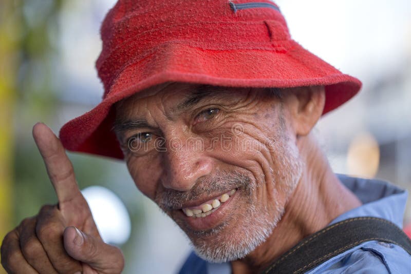 Positive portrait of a thai man in street market, close up. Bangkok, Thailand