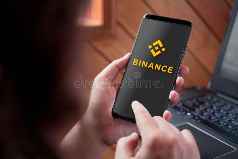 Bangkok, Thailand - Septempber 3, 2019: Hand holding smartphone with Binance logo on screen. Binance is a global cryptocurrency