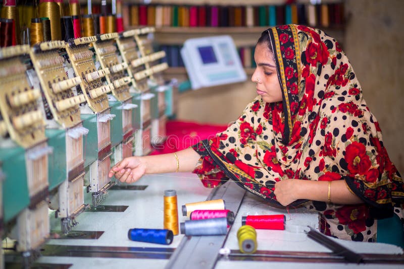 Bangladesh â€“ August 6, 2019: A Bangladeshi woman garments worker working with Computerized Embroidery Machine at Madhabdi