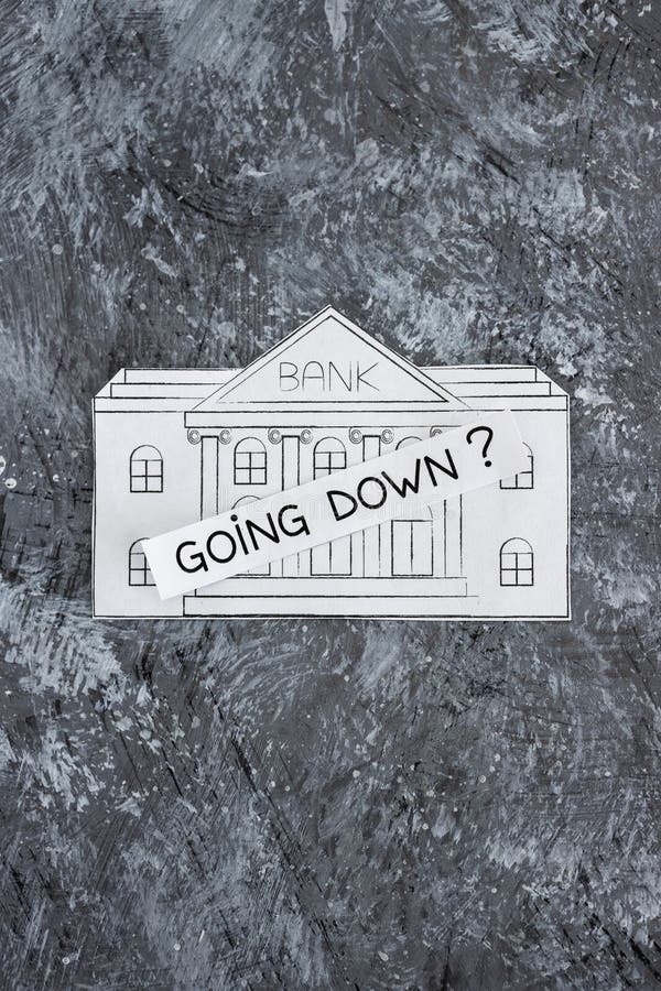 Insolvency and banks closing down concept, bank made of paper with Going Down ? caption above it stock photo Insolvency and banks closing down concept, bank made of paper with Going Down ? caption above it stock photo