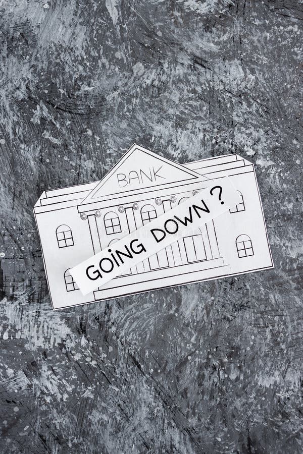 Insolvency and banks closing down concept, bank made of paper with Going Down ? caption above it stock photo Insolvency and banks closing down concept, bank made of paper with Going Down ? caption above it stock photo
