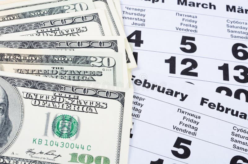 Banknotes of dollars on calendar sheets closeup