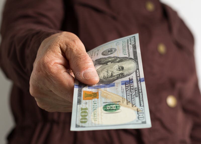 Banknotes of USA currency: Dollar. Old retired person paying in cash stock image Banknotes of USA currency: Dollar. Old retired person paying in cash stock image