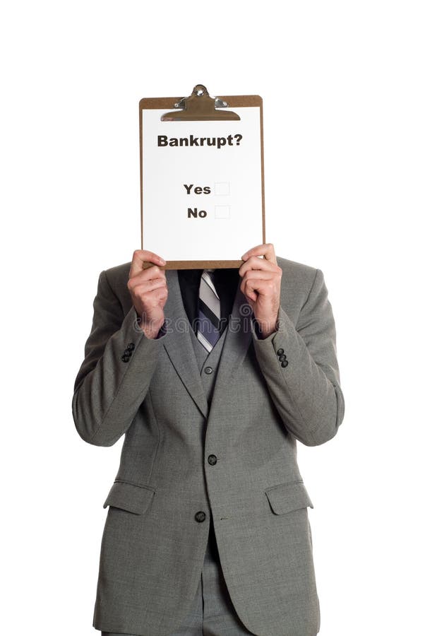 Businessman wearing a grey suit is holding a survey in front of his head that is asking people if they are bankrupt or not, isolated against a white background