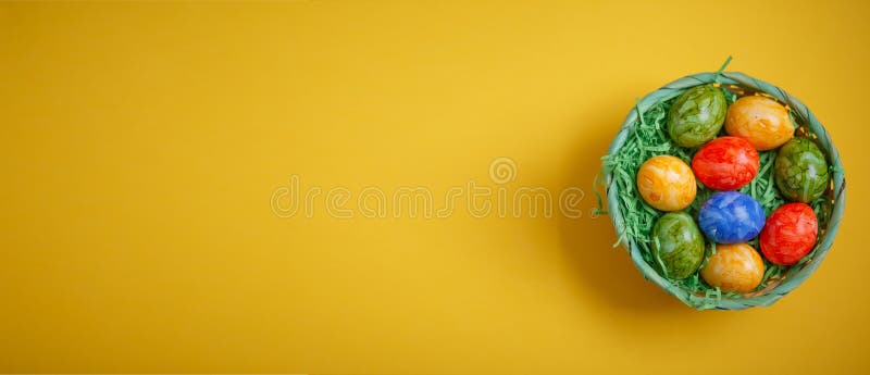 Banner for easter card. Flat lay composition with Easter eggs on yellow background