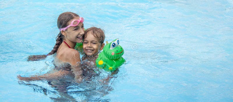 Little boy smiling in the Pool.
