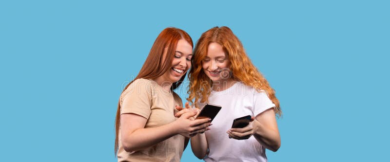 Banner, long format on blue background. Friendship. Two girls friends looking in smartphone, gossiping on slumber party