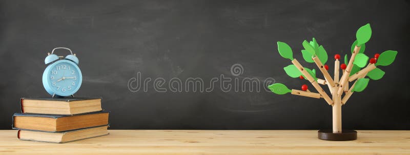banner of open book and wooden tree puzzle over blackboard background. education and knowledge concept. royalty free stock photos banner of open book and wooden tree puzzle over blackboard background. education and knowledge concept. royalty free stock photos