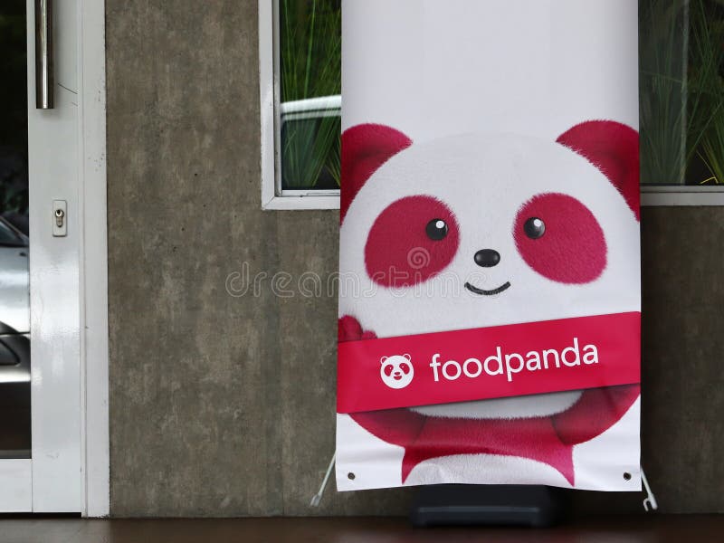 A big banner at the front of a store in Malaysia promoting the door-to-door food delivery service by Foodpanda. A big banner at the front of a store in Malaysia promoting the door-to-door food delivery service by Foodpanda