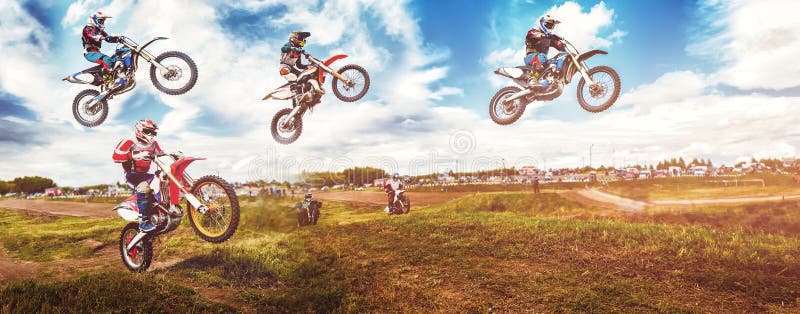 Banner rider on mountain dirtbike enduro participates in motocross, jumps on springboard against background dirt