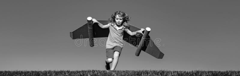Banner with spring kids portrait. Happy child running with toy wings against summer sky background. Kids success, leader royalty free stock photo