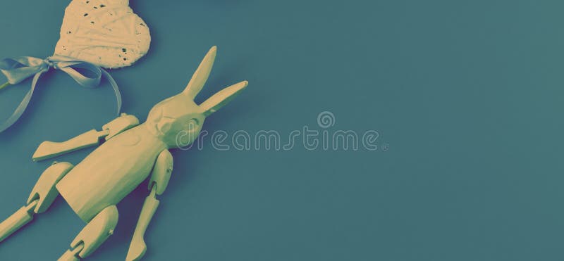 Banner Surrealism composition vintage wooden rabbit on dark blue background. stock images Banner Surrealism composition vintage wooden rabbit on dark blue background. stock images
