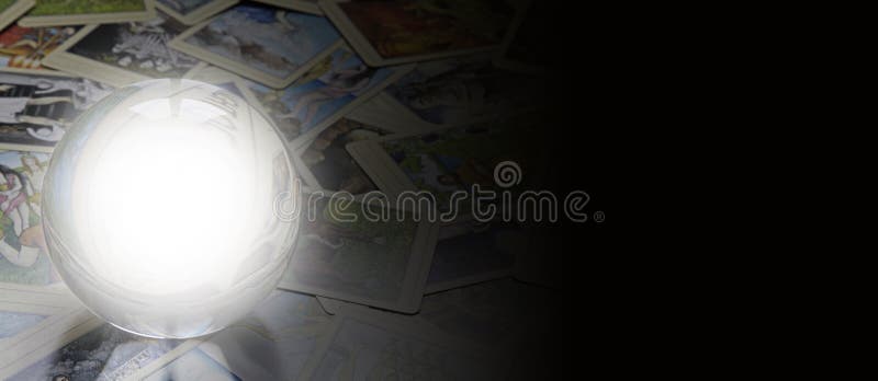Crystal Ball with white empty center laid on scattered tarot cards faded off to the right merged with black for a wide web banner. Crystal Ball with white empty center laid on scattered tarot cards faded off to the right merged with black for a wide web banner
