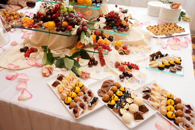 Banquet table full of sweets, fruits and berries - catering event, wide angle shot