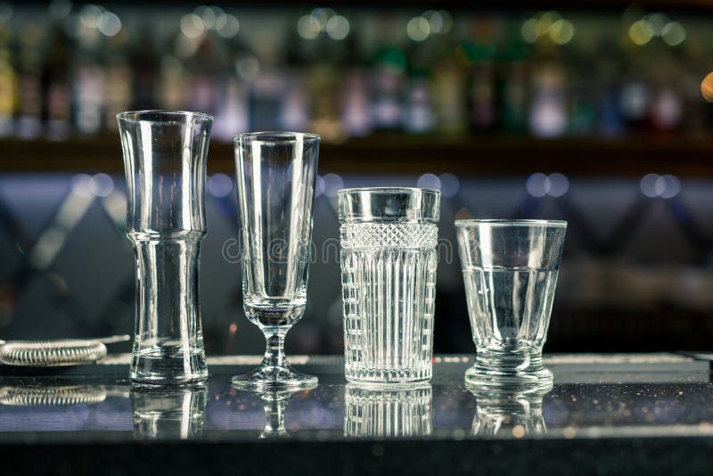 Bar Counter with Empty Glasses. Assorted Empty Glasses and Cocktail