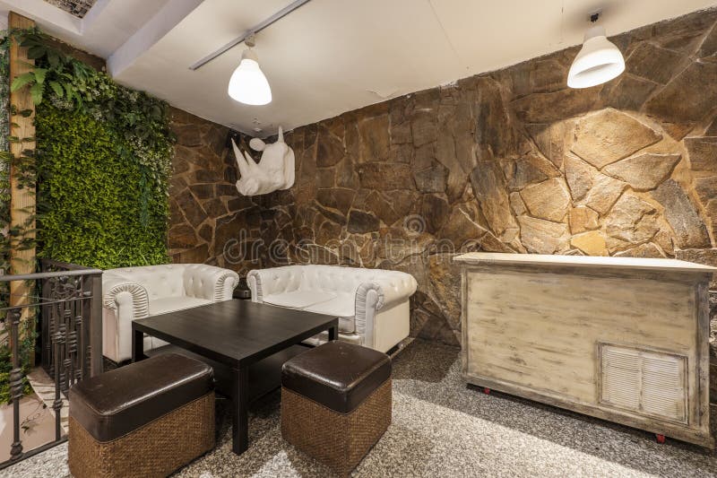 A Bar Room with Chester Style Sofas and a Black Metal Wrought Iron