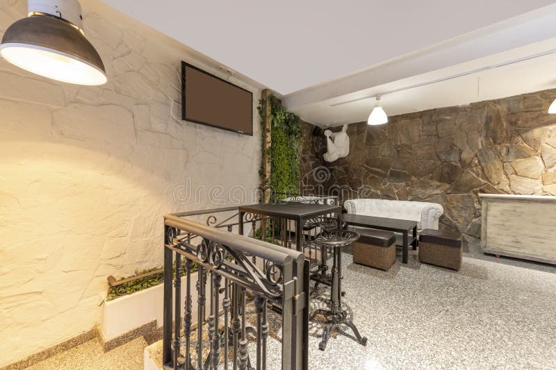 A Bar Room with Chester Style Sofas and a Black Metal Wrought Iron