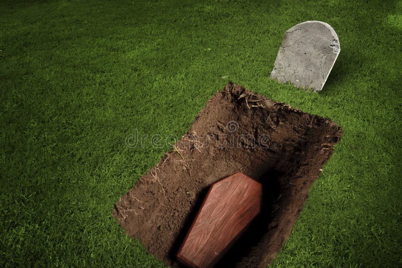 Photo of wooden coffin at a graveyard. Photo of wooden coffin at a graveyard