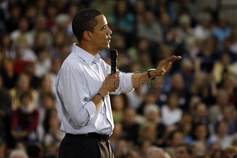 Barack Obama captured with an reassuring gesture toward a crowd of supporters. Outreached hand has slight motion blur. Barack Obama captured with an reassuring gesture toward a crowd of supporters. Outreached hand has slight motion blur.