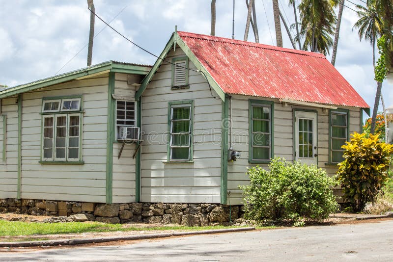 Barbados Chattel House in local district. Tall Coconut trees in the background. Barbados Chattel House in local district. Tall Coconut trees in the background.