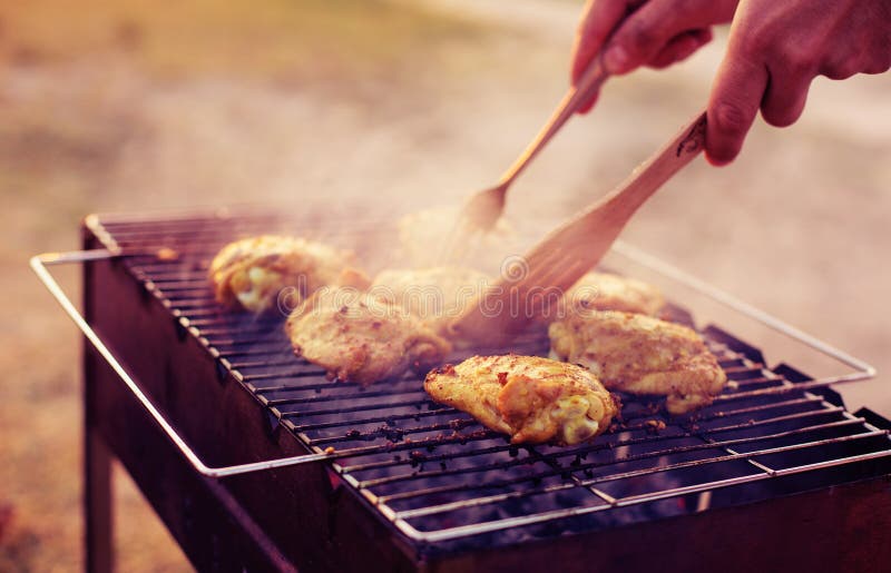 Chef Cooking Jerk Barbecue BBQ Chicken on the Grill Hand Turning Food