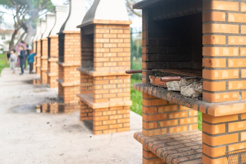 Barbecue Fireplace with Stack of Chopped Firewood in Park Stock Image