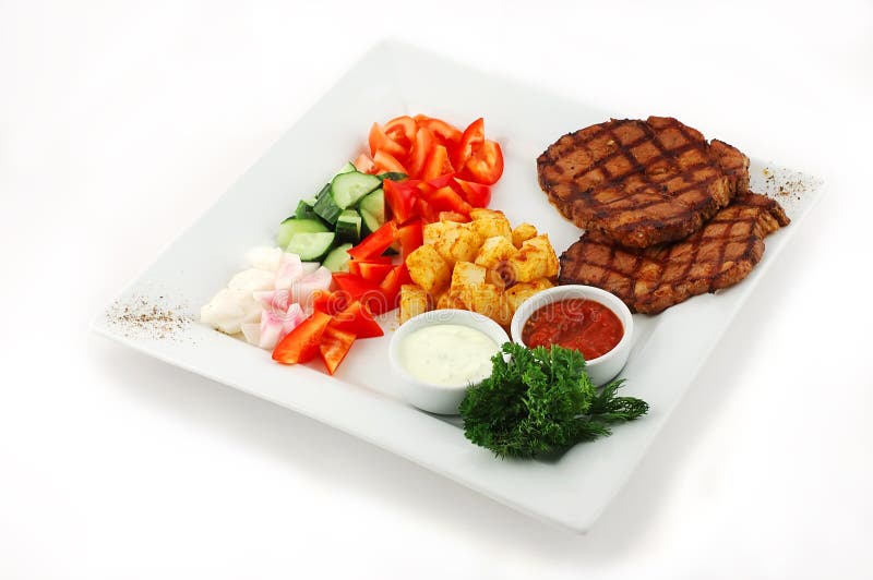 Barbecue with salad on a square plate