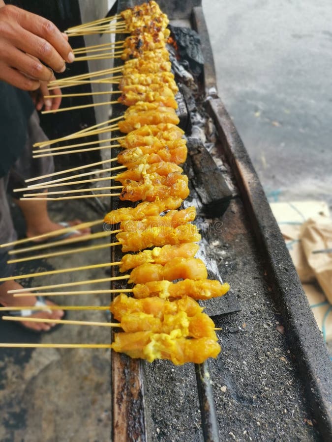 Barbecuing Sticks of Marinated and Bitesize Pieces of Chicken Meat